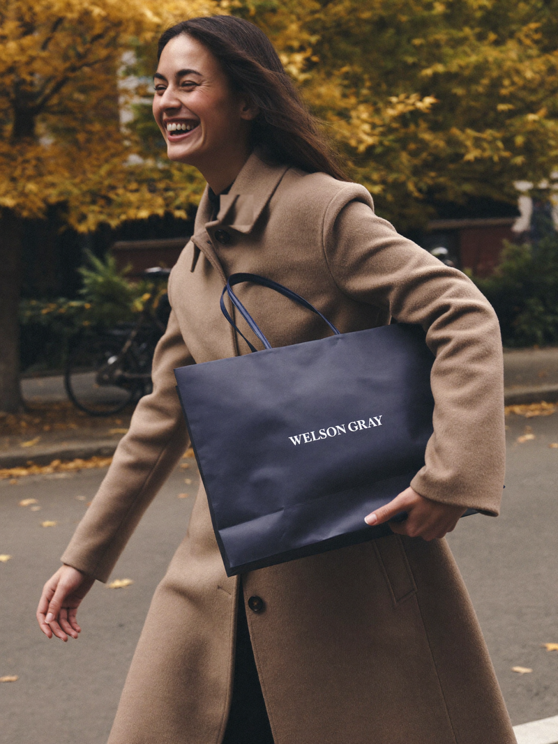 Customer with a Welson Gray shopping bag on an autumn street